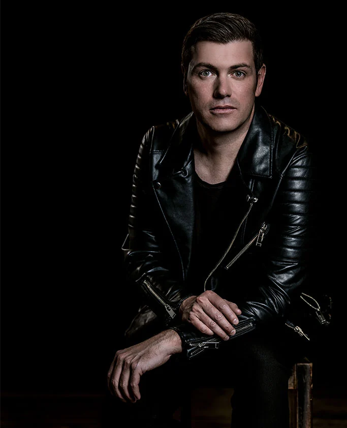 Jolyon Petch seated in a black leather jacket